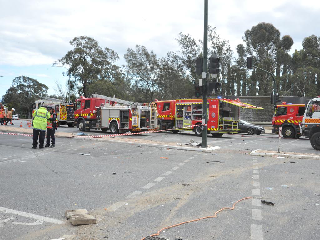 Emergency service workers at the crash on the corner of Glen Osmond and Cross roads. Picture: Roger Wyman