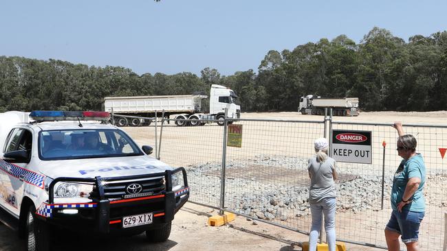 Black Swan Lake protest at Bundall goes to another level, with protesters chaining themselves to the fence and then getting themselves arrested after running onto the worksite and stopping the trucks. The trucks roll in as protesters are taken away in Paddy wagon. Picture Glenn Hampson