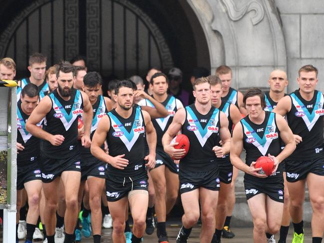 Power players run onto the field during the Round 9 AFL match between the Gold Coast Suns and the Port Adelaide Power