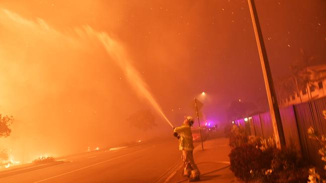 A firefighter in action during the Peregian bushfire. Picture: Patrick Woods / Sunshine Coast Daily.