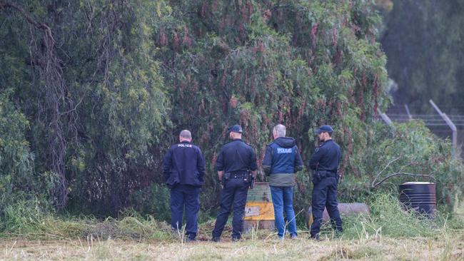 Police search through trees in the vacant paddock on Cheviot Rd in Salisbury South where Mr McLean’s torso was found. Picture: Brenton Edwards