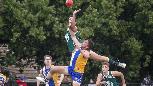 Nathan Howard jumps over Zach Hudson. Picture: Valeriu Campan