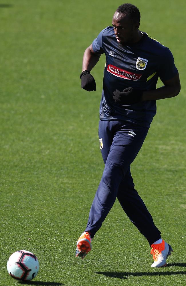 Usain Bolt warms up the Central Coast’s Gosford stadium. Picture: Brett Costello