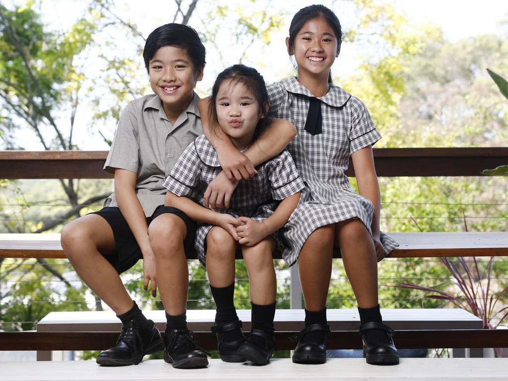 Youngest siblings Roman Crescini (9) Mayumi Crescini (5) and Emerald Crescini (11) go to a local Catholic primary school in Sydney’s Hills district. Picture: Richard Dobson