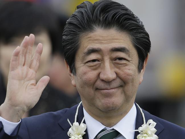 Japanese Prime Minister Shinzo Abe waves as he arrives at Manila airport, Philippines, Thursday, Jan. 12, 2017. Abe is in the country for a two-day official visit. (AP Photo/Aaron Favila)