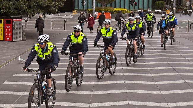 Police officers ride their bikes through Southbank. Picture: William West/AFP