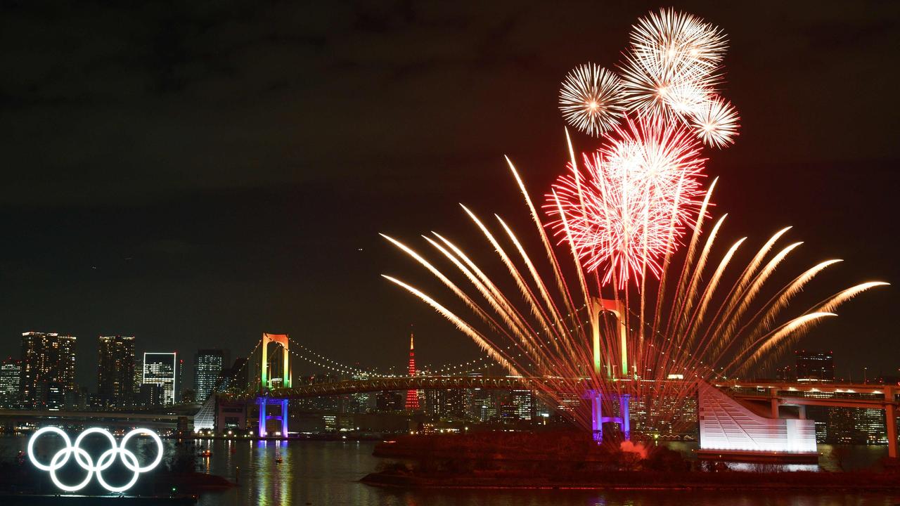 A backdrop of fireworks to the Olympic rings in Tokyo give a taste of what’s ahead. Picture: AFP