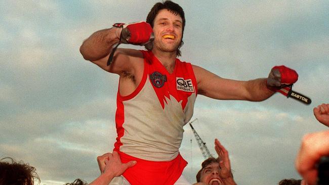 Paul Roos is chaired off field by Sydney Swans teammates playing his 300th AFL game. Picture: John Feder