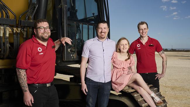 Aaron Lock with daughter Charlotte, 10, and Coles staff at the future site of Riverlea’s new supermarket. Picture: Matt Loxton