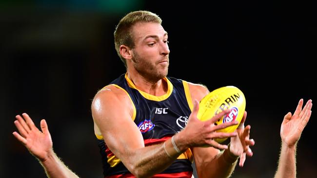 ADELAIDE, AUSTRALIA - APRIL 04:Daniel Talia of the Adelaide Crows marks in front of Luke Dahlhaus of the Cats  during the round three AFL match between the Adelaide Crows and the Geelong Cats at Adelaide Oval on April 04, 2019 in Adelaide, Australia. (Photo by Mark Brake/Getty Images)