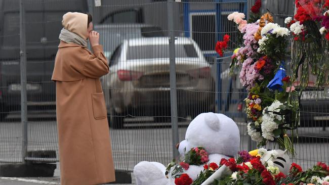 A woman mourns at a makeshift memorial in front of the Crocus City Hall. Picture: AFP