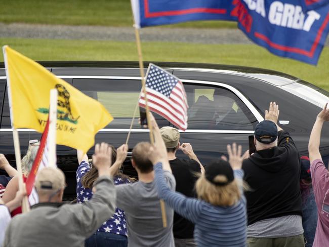 US President Donald Trump gestures to supporters from his motorcade in Allentown, Pennsylvania. Picture: AP