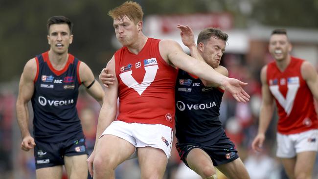  North's Mitchell Harvey gets a kick away under pressure from Norwood's Zac Richards. Picture Dean Martin