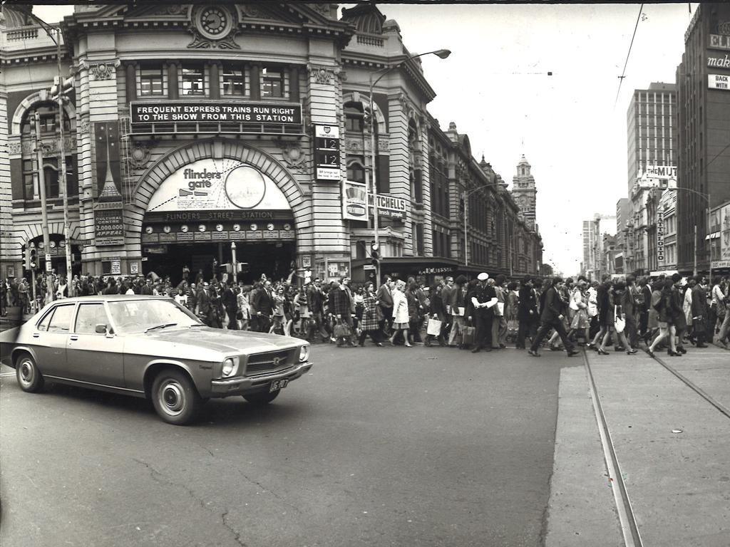 1974. The busy Flinders Street, Swanston Street intersection. Traffic.