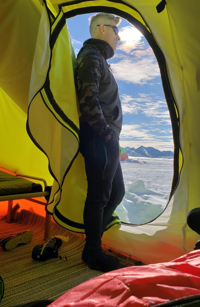 Justin Quill peering out of one of the Union Glacier Camp’s clam tents. 