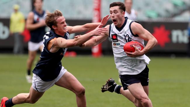 Lachlan Ash of Vic Country evades a tackle during the under-18s championships.