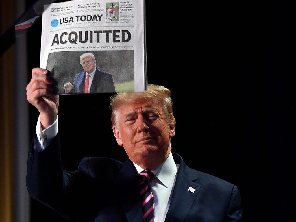 The President holds up a newspaper that displays a headline "Acquitted" as he arrives to speak at the 68th annual National Prayer Breakfast in Washington, DC. In his first public comments since being acquitted by the Senate of abuse of office, he said he had been "put through a terrible ordeal by some very dishonest and corrupt people." "They have done everything possible to destroy us and by so doing very badly hurt our nation," he said at a televised prayer breakfast with a Who's Who of Washington powerbrokers. Picture: AFP