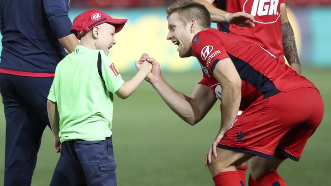 Ace Kounavis and Adelaide United winger Ryan Kitto on the Hindmarsh pitch following the Reds’ A-League win over Melbourne Victory. Picture: Sarah Reed