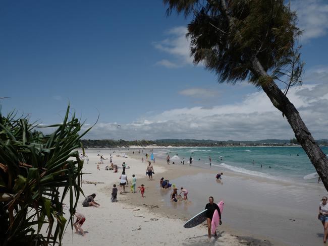 BYRON BAY, AUSTRALIA - NOVEMBER 06: People enjoy the sunshine at Clarkes Beach on November 06, 2021 in Byron Bay, Australia. COVID-19 travel restrictions eased on Monday 1 November to allow people from Greater Sydney to visit New South Wales regional areas. (Photo by James D. Morgan/Getty Images)