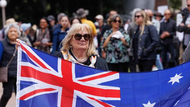 A woman holding an Australian flag at the rally. Picture: NCA NewsWire / David Swift