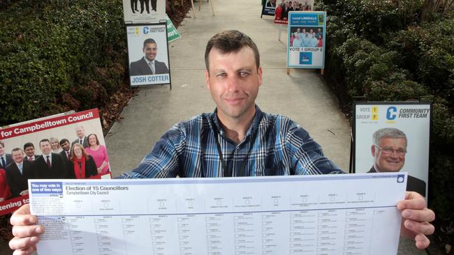 Campbelltown Council election returning officer Andrew Bzadough holding the massive ballot paper for the council elections — the biggest ballot paper in NSW.