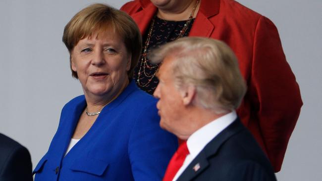 German Chancellor Angela Merkel and US President Donald Trump talk during the opening ceremony of the NATO. (Pic: Geoffroy Van Der Hasselt/AFP)