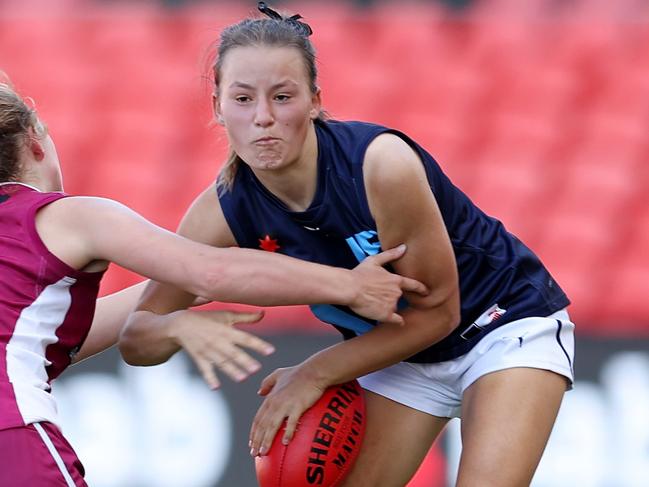 GOLD COAST, AUSTRALIA - APRIL 19: Lulu Beaty of Metro is tackled during the Under 18 Girls Championship match between Queensland and Vic Metro at Metricon Stadium on April 19, 2022 in Gold Coast, Australia. (Photo by Chris Hyde/AFL Photos)