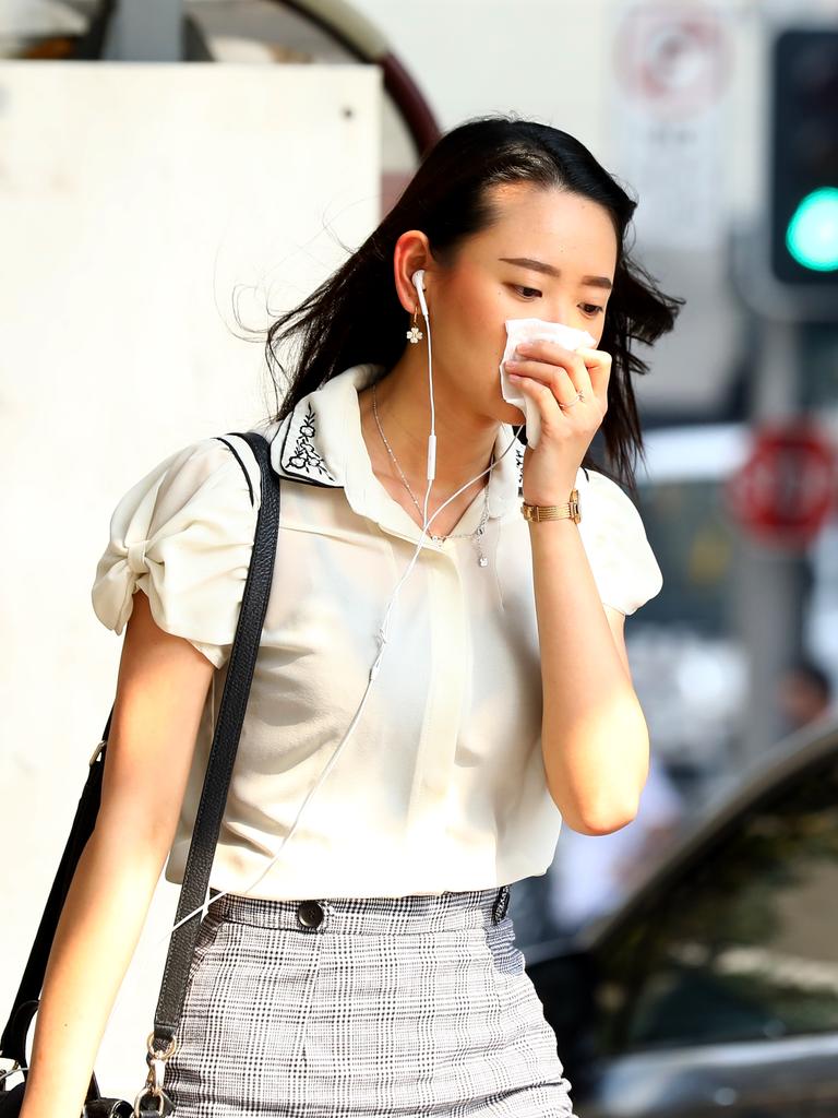 As smoke from bushfires engulfs Sydney, morning commuters are pictured wearing face masks as they make their way to work. Picture: MATRIX