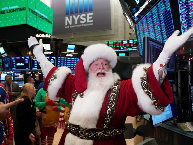 Santa Clause gestures on the floor at the closing bell of the Dow Industrial Average at the New York Stock Exchange on December 5, 2019 in New York. - Wall Street stocks finished slightly higher  following a choppy session that avoided the big swings from earlier in the week on trade-oriented headlines. US and Chinese negotiators are working to finalize a preliminary trade deal announced in October that would block new tariffs expected to take effect this month. Officials have sent mixed signals on the talks, sending shares gyrating. (Photo by Bryan R. Smith / AFP)