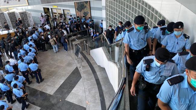 Hong Kong police raid the offices of Hong Kong tabloid Apple Daily.