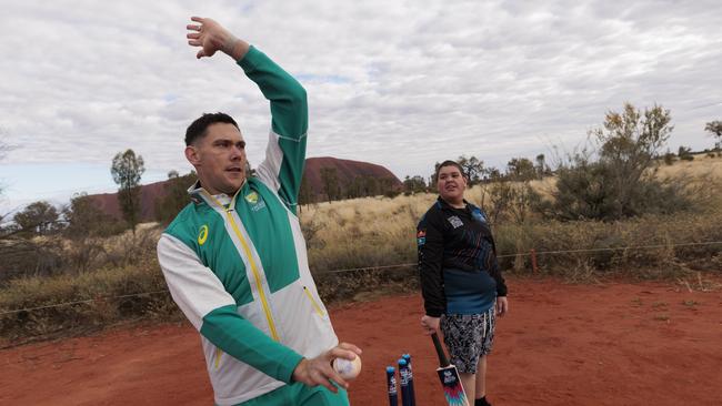 Boland teaches some local school kids a few pointers about the game of cricket during his visit to Uluru. Picture: Brook Mitchell/Getty Images