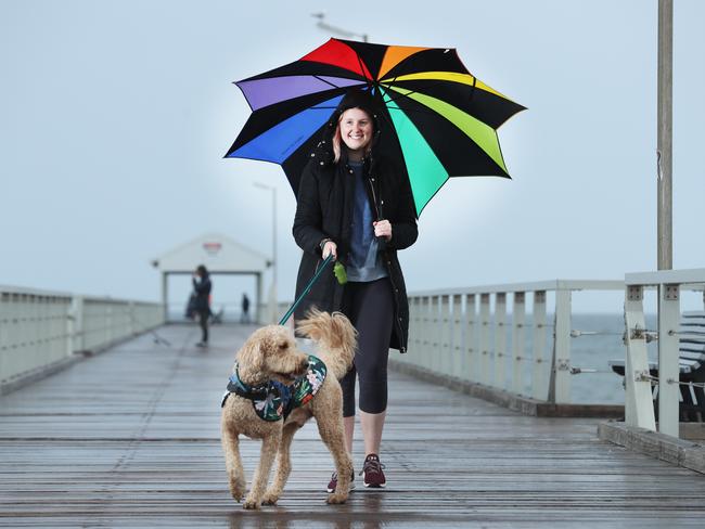 28.4.2020.Sarah Golfis,24 of Joslin with her dog Frank at Henley Beach as a cold weather front hits the south of Australia .( 0430 192 869).PIC TAIT SCHMAAL.