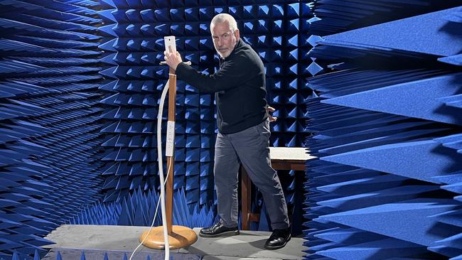 Technology specialist Lindsay Munks grasps a phone in different grips as part of Blue Tick testing at Telstra's testing facility.