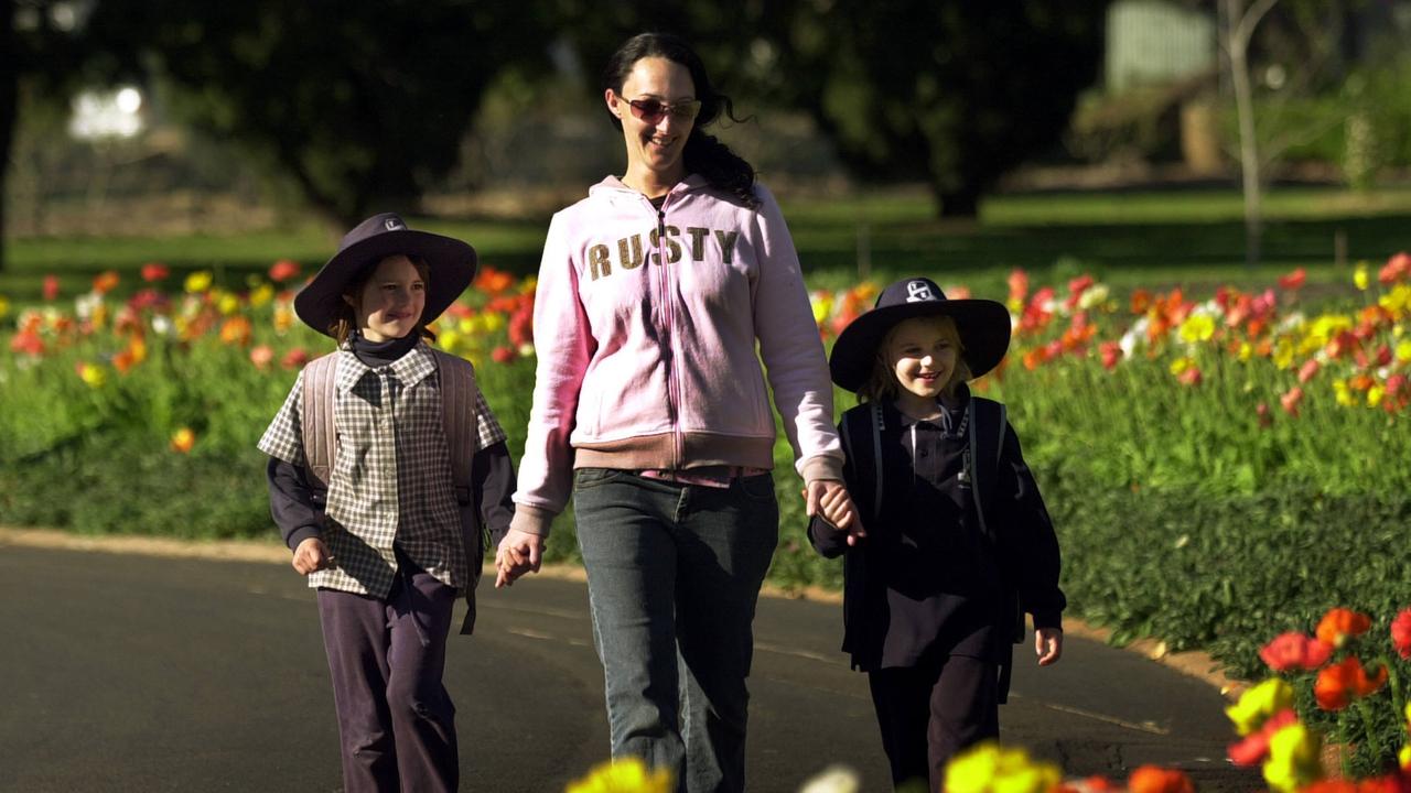 Niece Chloe McPartlan 6yrs with her Aunty Renee Mudford along with daughter Bree Trunley 7yrs walk home from school through Queens Park. Picture: David Martinelli.