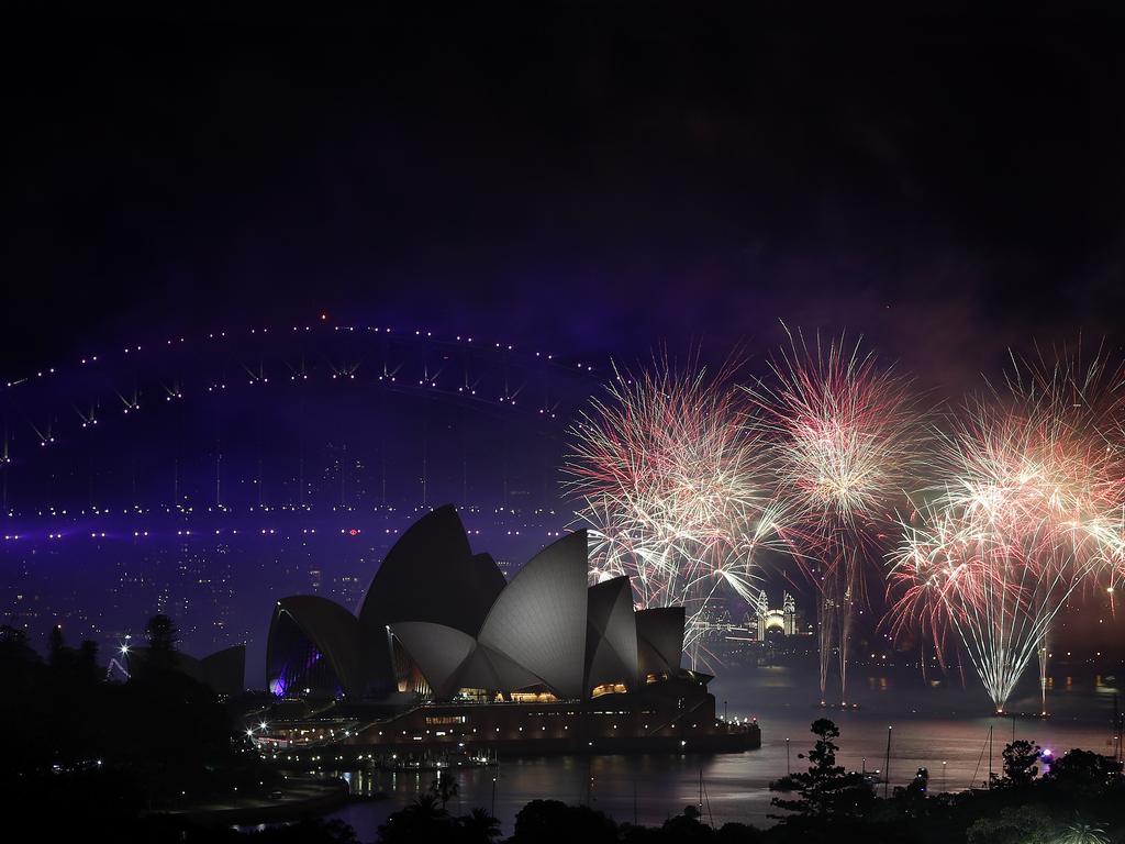 New Year's Eve 2018 - The midnight fireworks display over the Sydney Opera House and Sydney Harbour Bridge from a rooftop in Potts Point. Picture: Toby Zerna