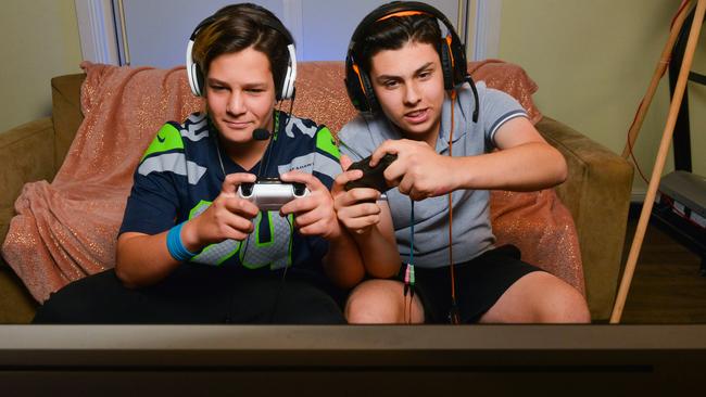 Cousins Riley and Ethan Donato playing the latest craze video game, Fortnite Battle Royale. Picture: AAP / Brenton Edwards