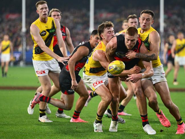 Peter Wright tries to bust through two tacklers.