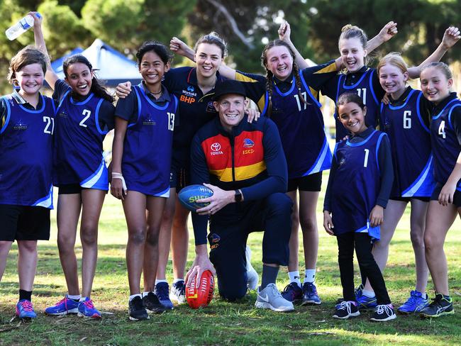Ebony Marinoff and Sam Jacobs with kids from Brompton Primary School girls football team at the Crows Cup on Friday. Picture: Mark Brake
