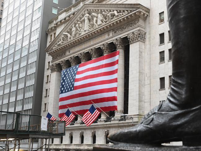 (FILES) In this file photo a view of the New York Stock Exchange is seen on Wall Street on March 23, 2020 in New York City. - Wall Street stocks opened solidly higher on April 14, 2020, bouncing back from a lackluster session as major banks kicked off earnings season in the wake of economic hit from coronavirus shutdowns. About 25 minutes into trading, the Dow Jones Industrial Average had gained 2.5 percent to 23,968.76.The broad-based S&P 500 also rose 2.5 percent to 2,829.53, while the tech-rich Nasdaq Composite Index jumped 2.9 percent to 8,433.39. (Photo by Angela Weiss / AFP)