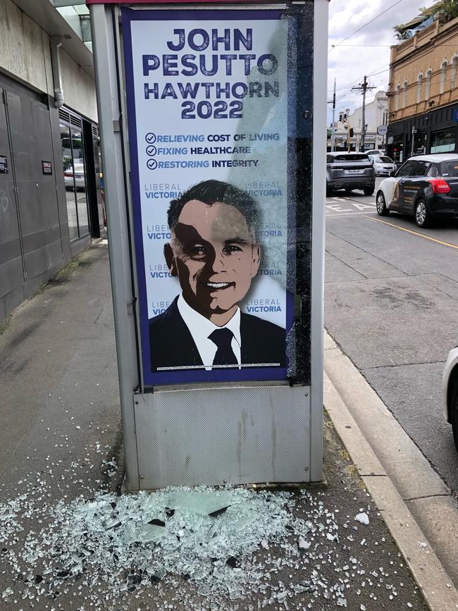 A vandalised phone booth displaying a poster of John Pesutto.