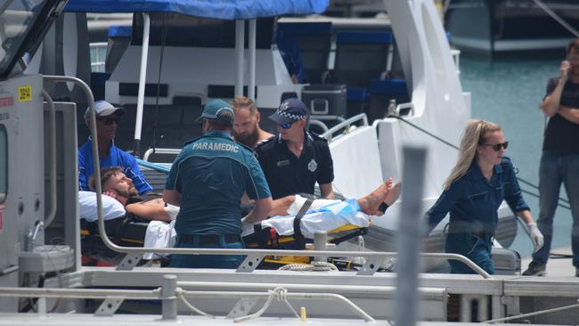 Authorities help a British backpacker following a shark attack on the Whitsundays.