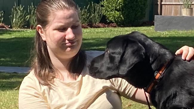 Good mates from their first meeting. Abbygail Crosby, from Pimpama on the northern Gold Coast, meets "Greg", a trainer assistance dog with the charity Empower Assistance Dogs.