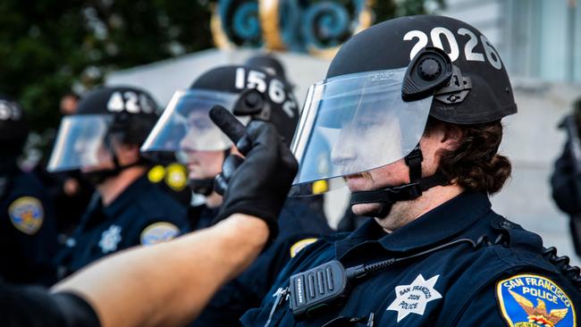 A demonstrator taunts a police officer during a protest in San Francisco. Picture: AFP