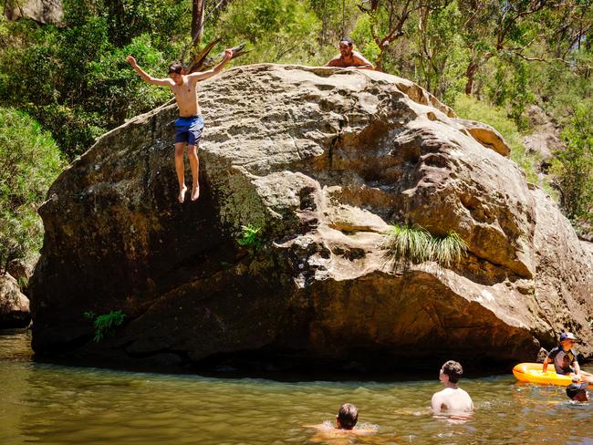 People cooling off by jumping into the water at Jellybean Pool in the Blue Mountains National Park at Glenbrook. Picture: Jonathan Ng