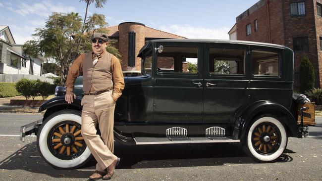 Moe Akgun owns Roaring Twenties Vintage Car Hire and leads art deco tours of Brisbane. Picture: AAP/Russell Shakespeare