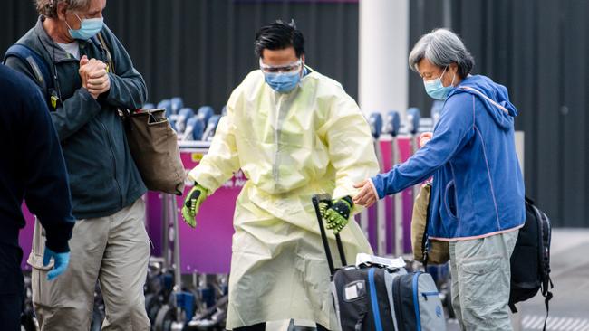 Passengers are loaded onto buses headed to the Pullman Hotel in Adelaide where they will quarantine for 14 days. Photo: The Advertiser/ Morgan Sette.