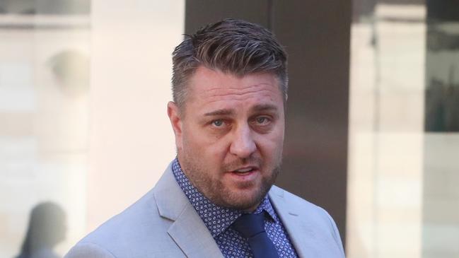 MELBOURNE, AUSTRALIA - NewsWire Photos, MARCH 26, 2024. (ID confirmed-Journo Liam Beatty) . Former AFL star Sam Fisher leaves the County Court of Victoria where he is facing  allegations he was involved in a cross-border drug trafficking operation.   Picture: NCA NewsWire / David Crosling