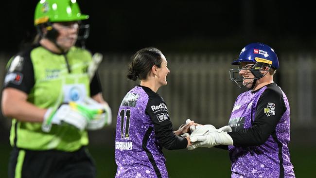 HOBART, AUSTRALIA - OCTOBER 28: Heather Graham and Lizelle Lee of the Hurricanes celebrates the wicket of Hannah Darlington of the Thunder during the WBBL match between Hobart Hurricanes and Sydney Thunder at Blundstone Arena on October 28, 2024, in Hobart, Australia. (Photo by Steve Bell/Getty Images)