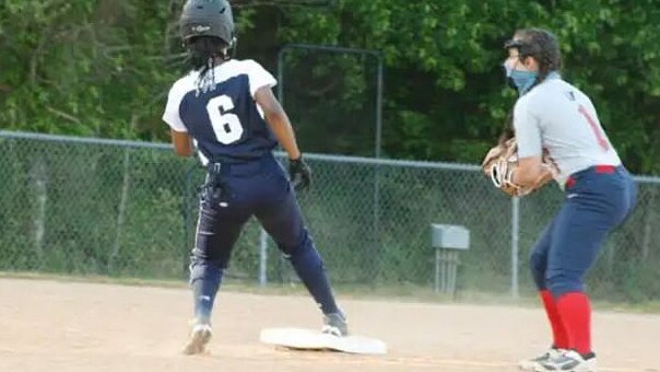 Nicole Pyles (number 6) with her beaded hair that umpires claimed obscured her jersey number when she was playing softball.