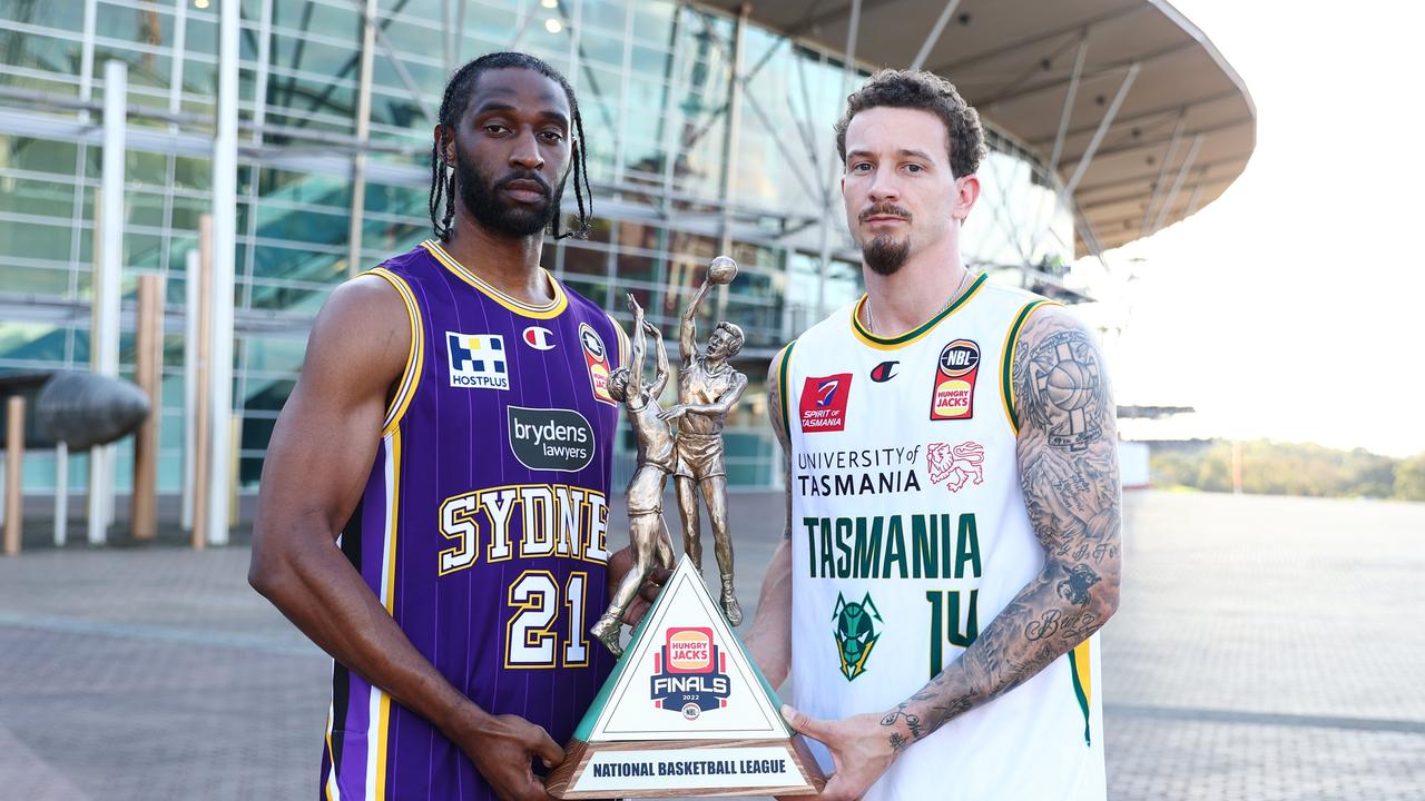 Josh Adams of the Tasmania JackJumpers and Ian Clark of the Sydney Kings pose with the NBL Championship Trophy.